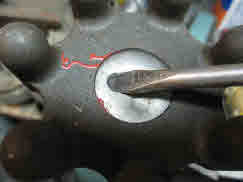 Drill hole in plug and pry out